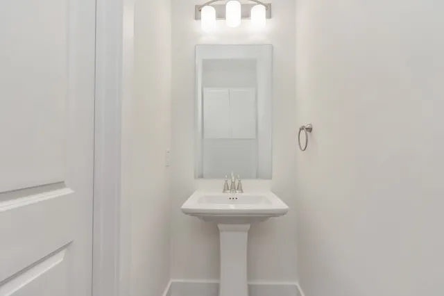 a bathroom with a sink a mirror and a window