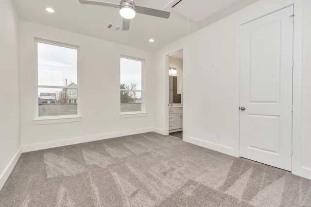 an empty room with windows and closet