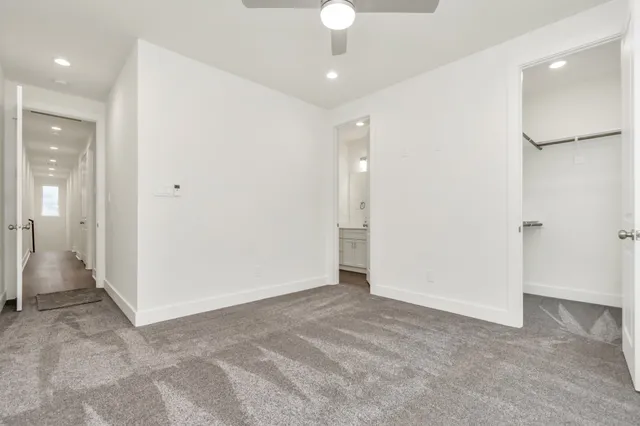 wooden floor in an empty room with a bathroom