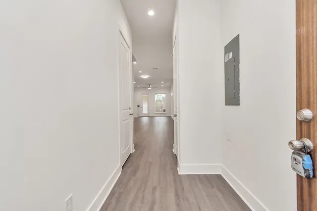 a view of a hallway with wooden floor
