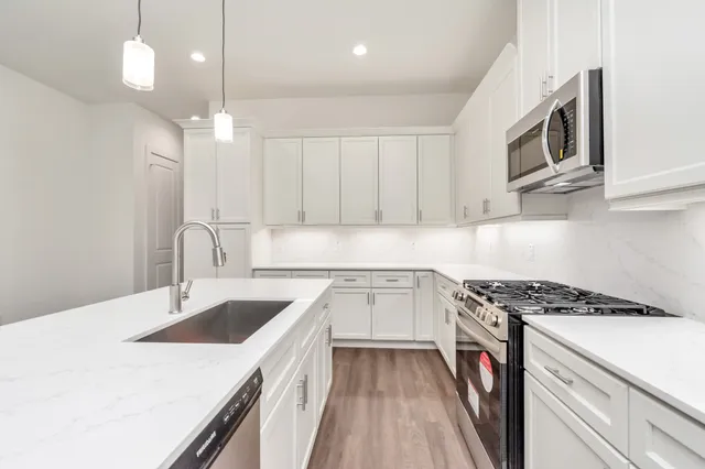 a kitchen that has a sink and a stove