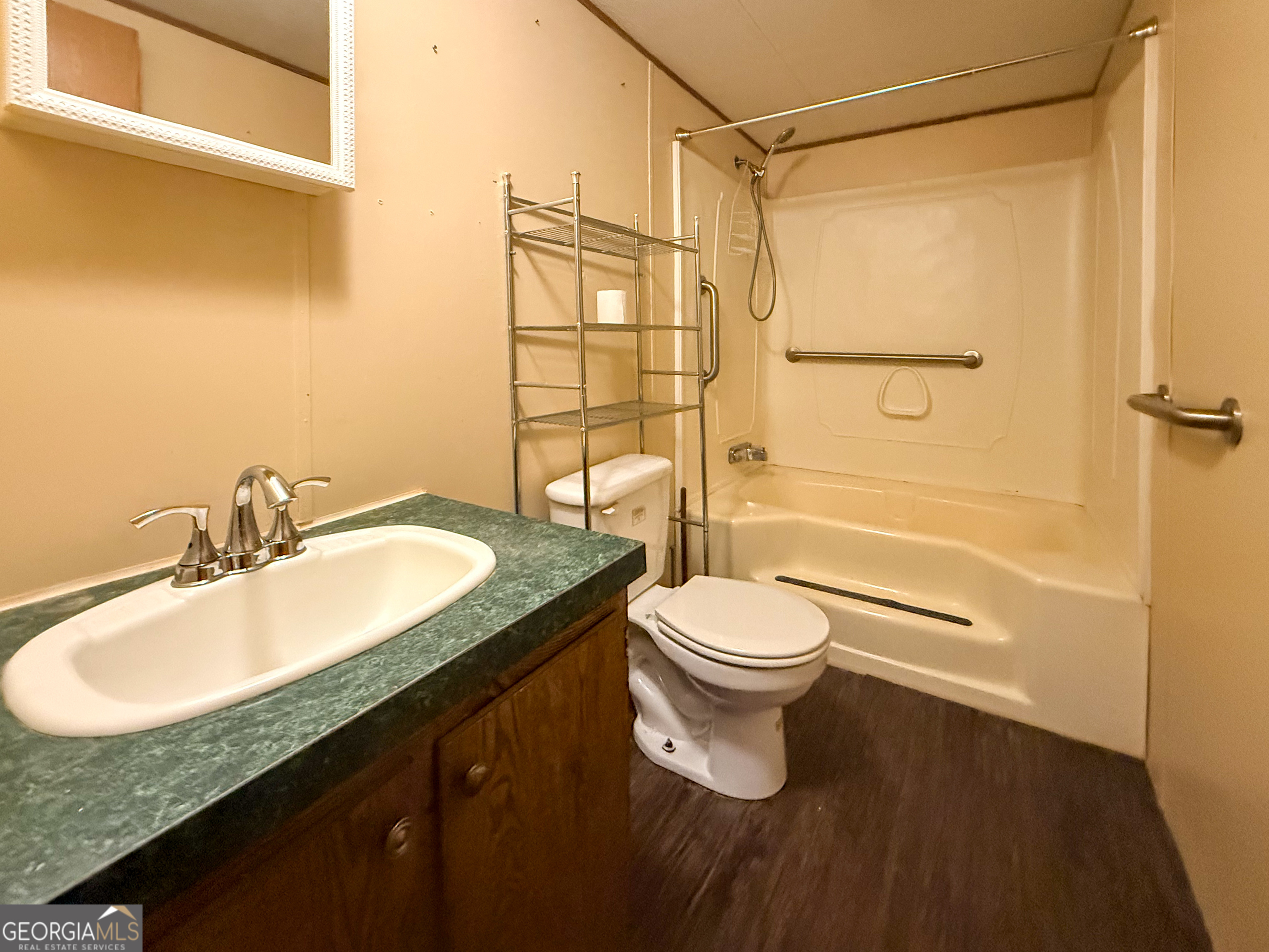 1177 Twin River Orchard Road Demorest, GA 30535 - Photo 12 of 27 a bathroom with a granite countertop sink toilet and shower