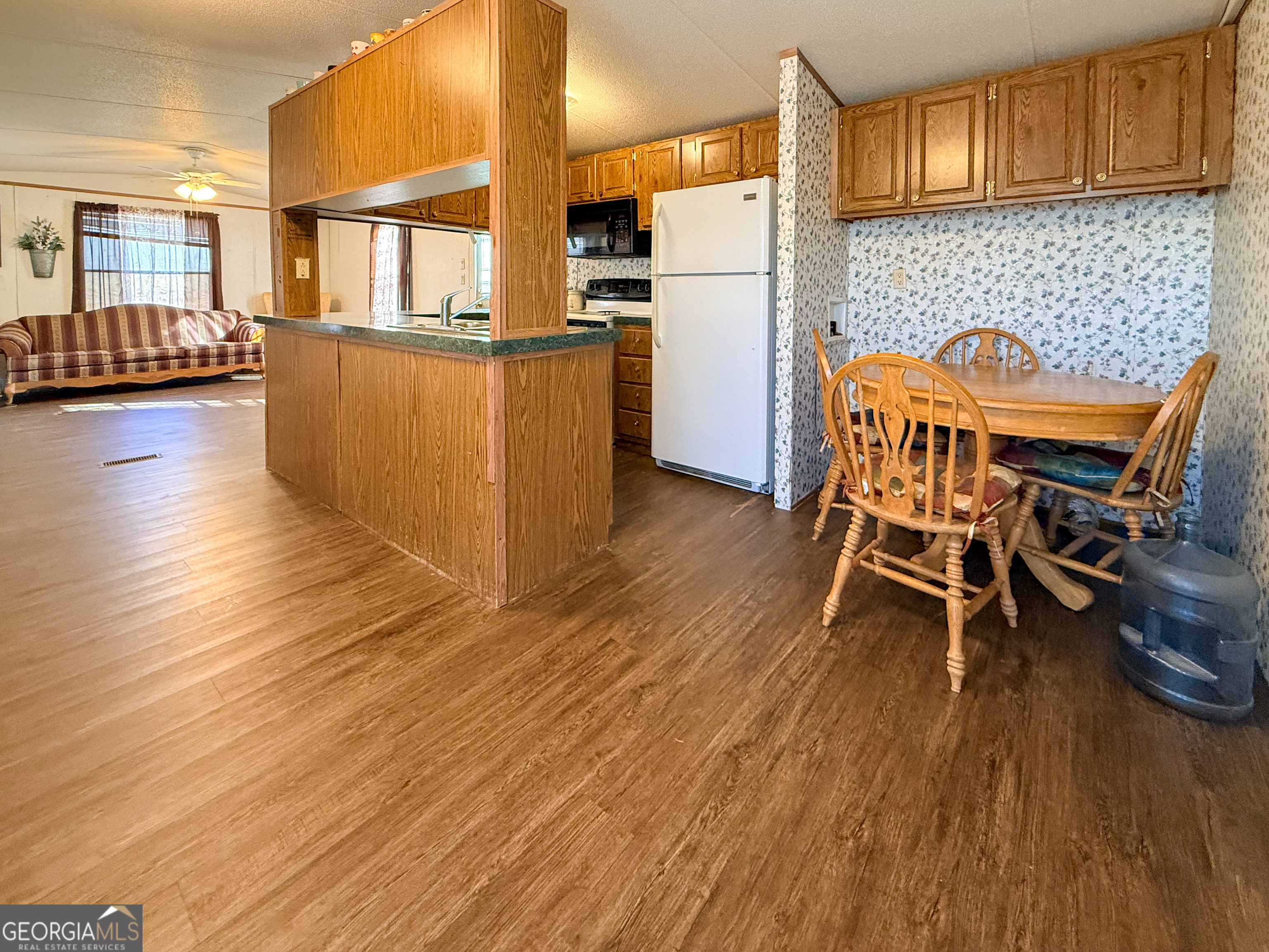 1177 Twin River Orchard Road Demorest, GA 30535 - Photo 6 of 27 a dining room with furniture and wooden floor