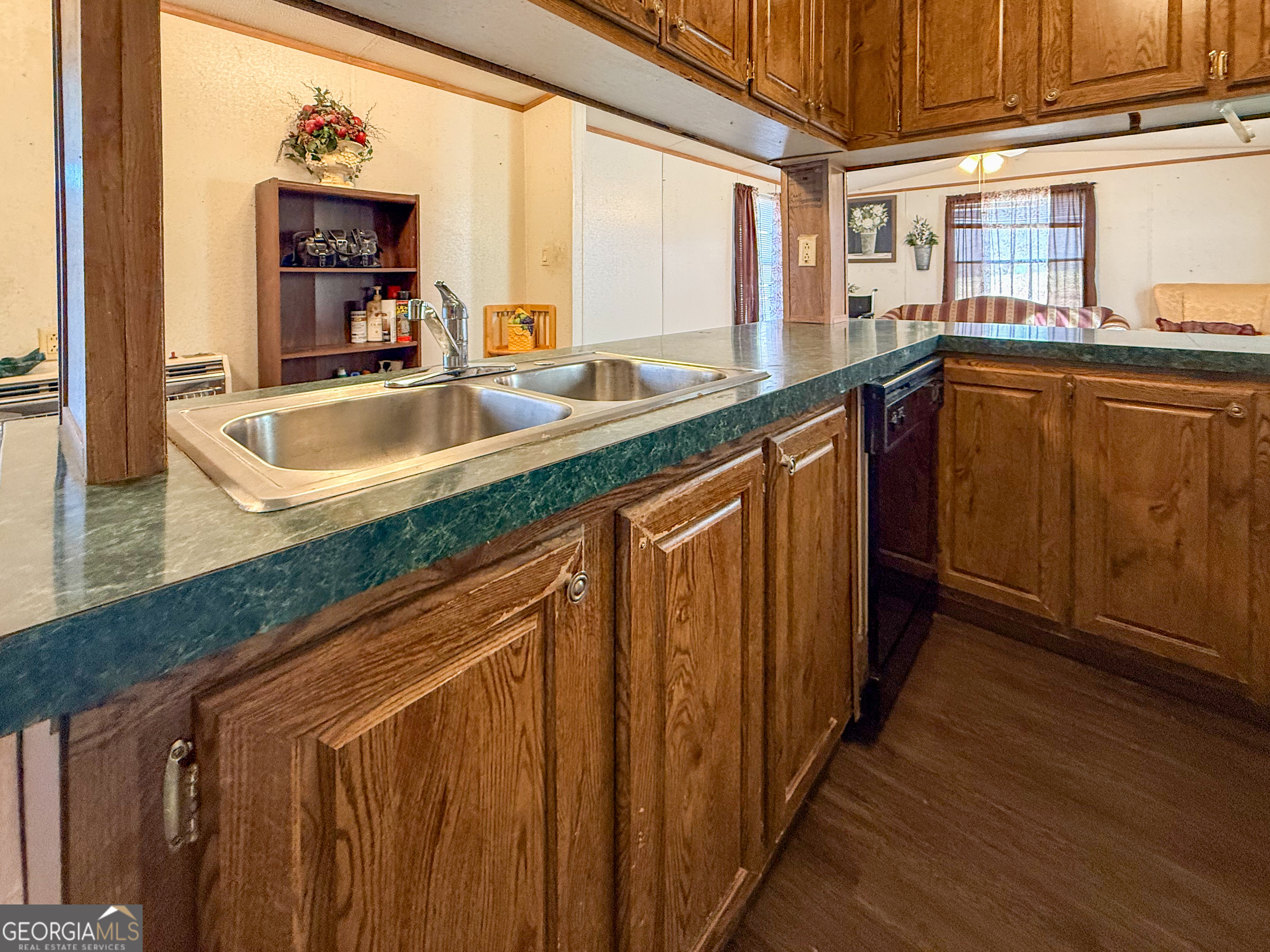 1177 Twin River Orchard Road Demorest, GA 30535 - Photo 8 of 27 a kitchen with granite countertop a sink and a wooden cabinets
