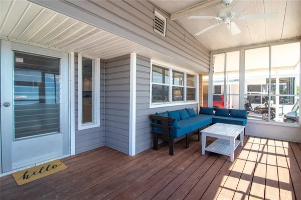 a view of a deck with couches and wooden floor