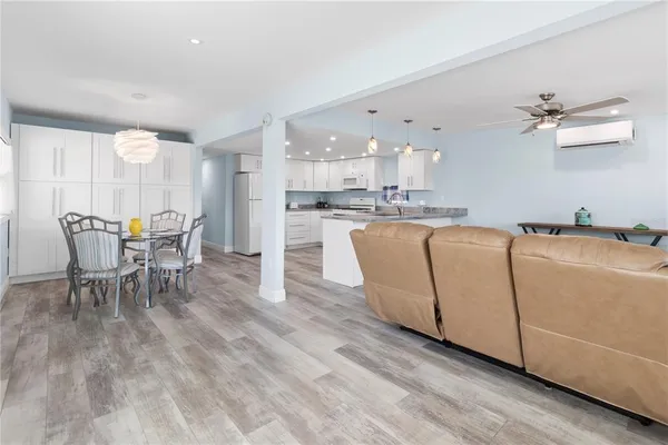 a living room with furniture a dining table and chairs