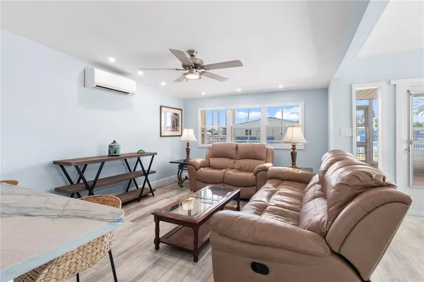 a living room with furniture and a ceiling fan