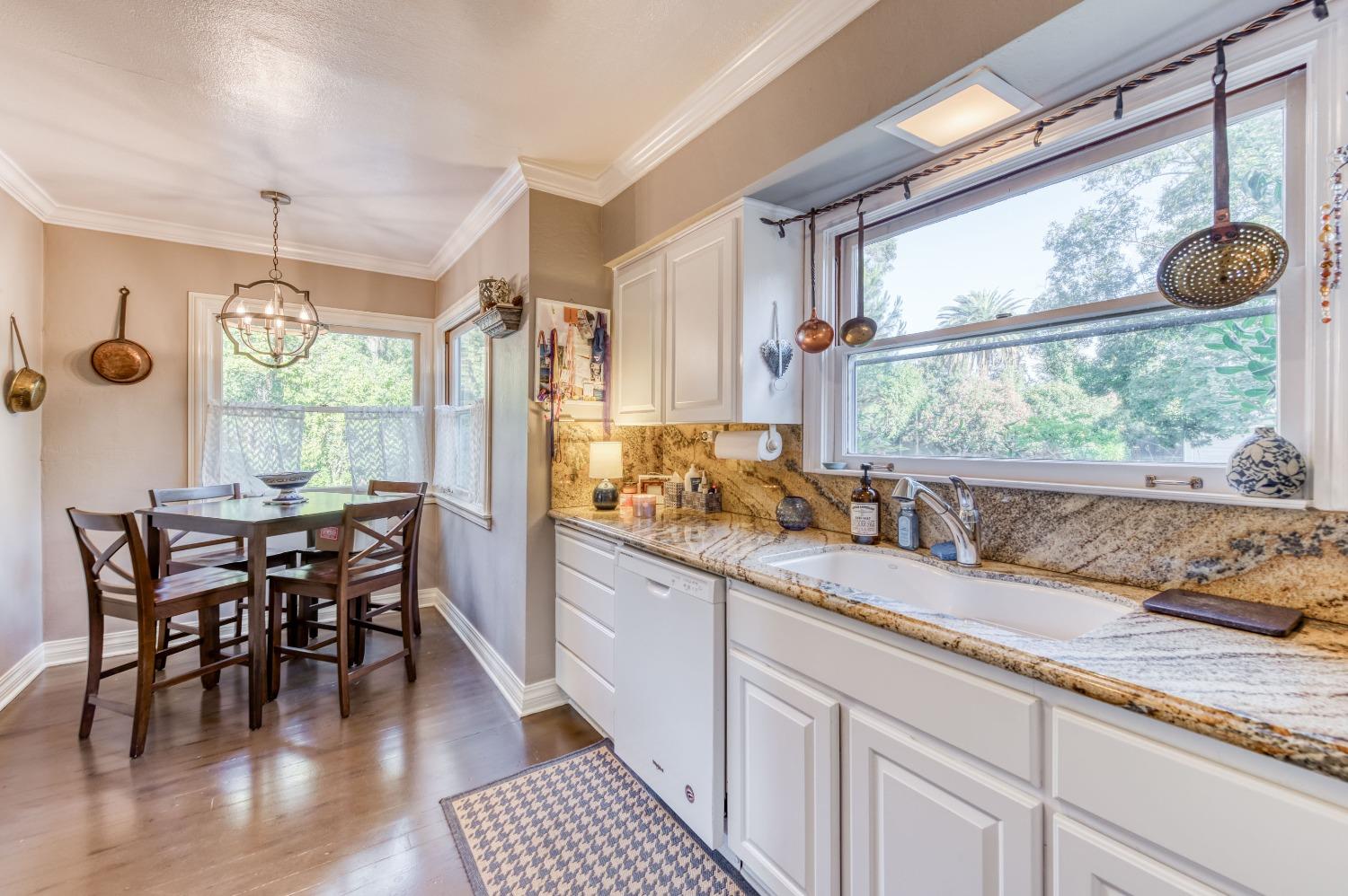 323 East Hampton Way Fresno, CA 93704 - Photo 13 of 44 a kitchen with stainless steel appliances granite countertop sink stove and wooden cabinets