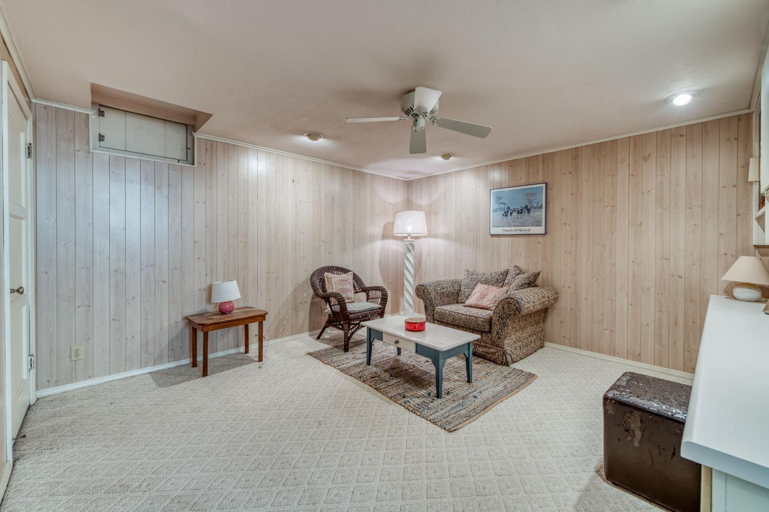 323 East Hampton Way Fresno, CA 93704 - Photo 29 of 44 a living room with furniture and a chandelier