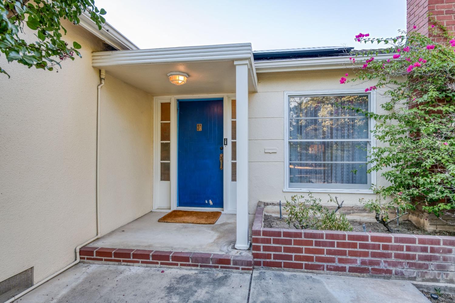 323 East Hampton Way Fresno, CA 93704 - Photo 3 of 44 a front view of a house with plants