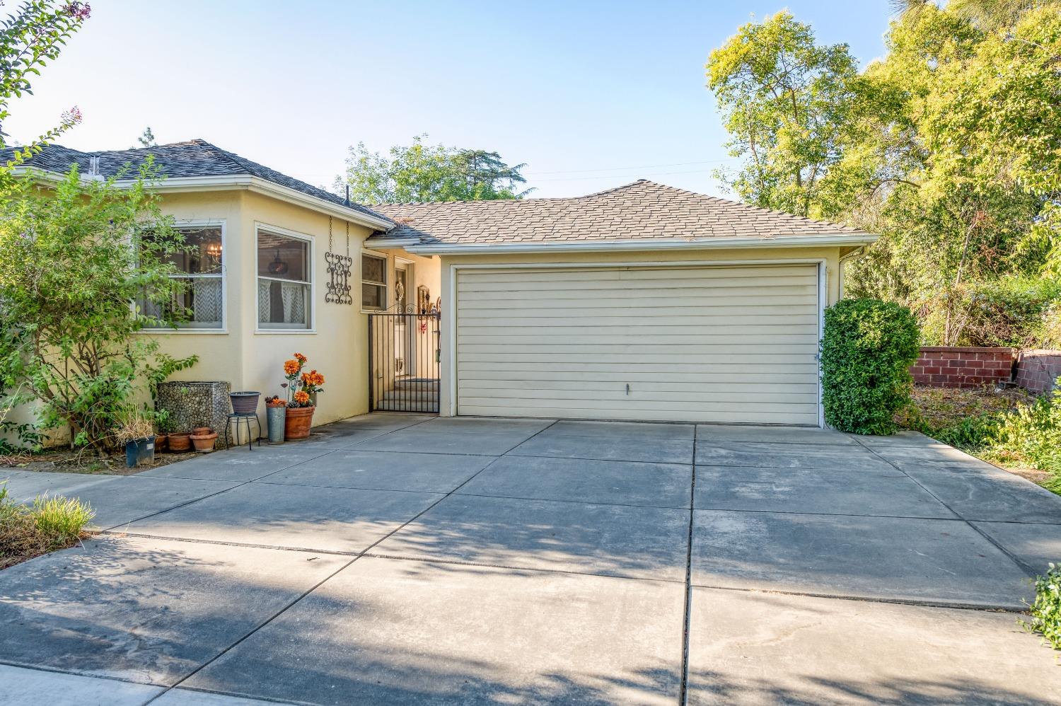323 East Hampton Way Fresno, CA 93704 - Photo 42 of 44 a view of house with a yard and potted plants
