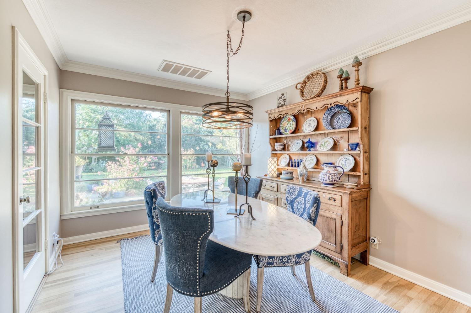 323 East Hampton Way Fresno, CA 93704 - Photo 8 of 44 a dining room with furniture a chandelier and wooden floor