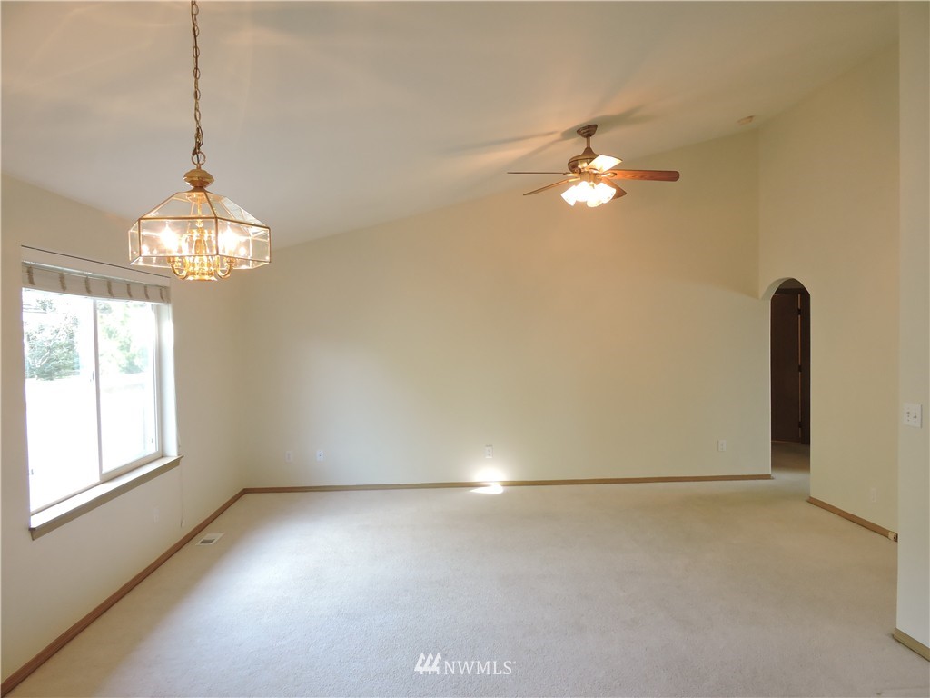 449 Spring Lane Sedro-Woolley, WA 98284 - Photo 4 of 11 a view of a chandelier in big room and chandelier fan