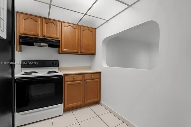 a kitchen with stainless steel appliances granite countertop a stove a microwave and cabinets