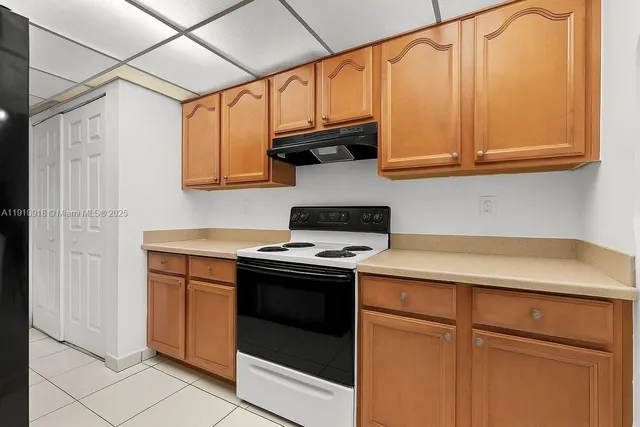 a kitchen with stainless steel appliances granite countertop a sink and a stove