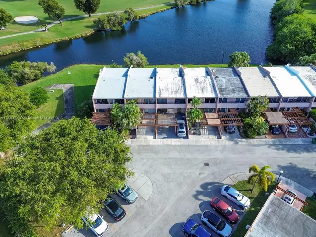 an aerial view of a house with garden space and lake view