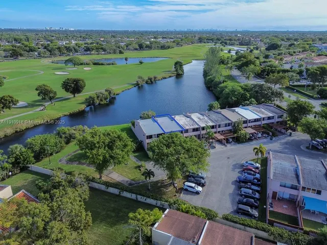 an aerial view of a houses with outdoor space and lake view