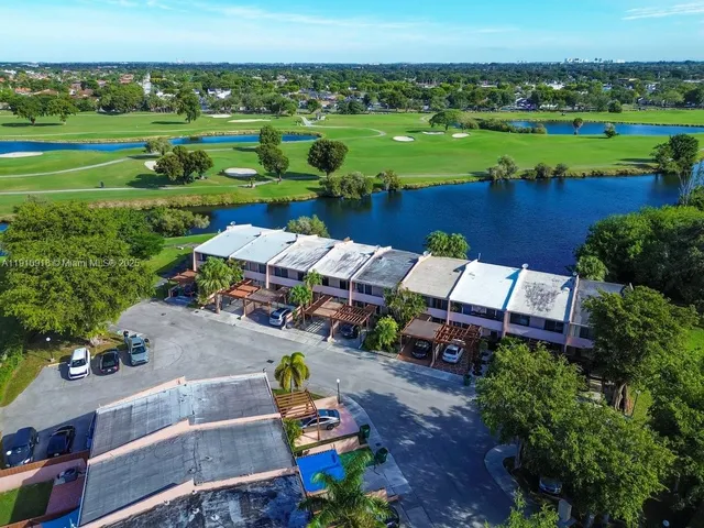 an aerial view of a house with a yard basket ball court and outdoor seating
