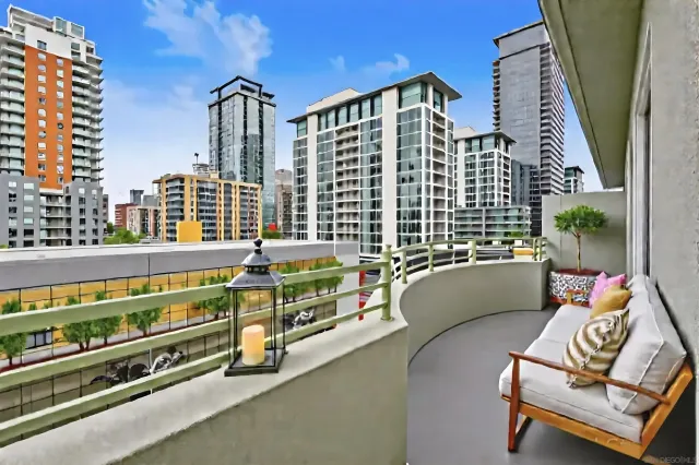 a roof deck with couch and chairs