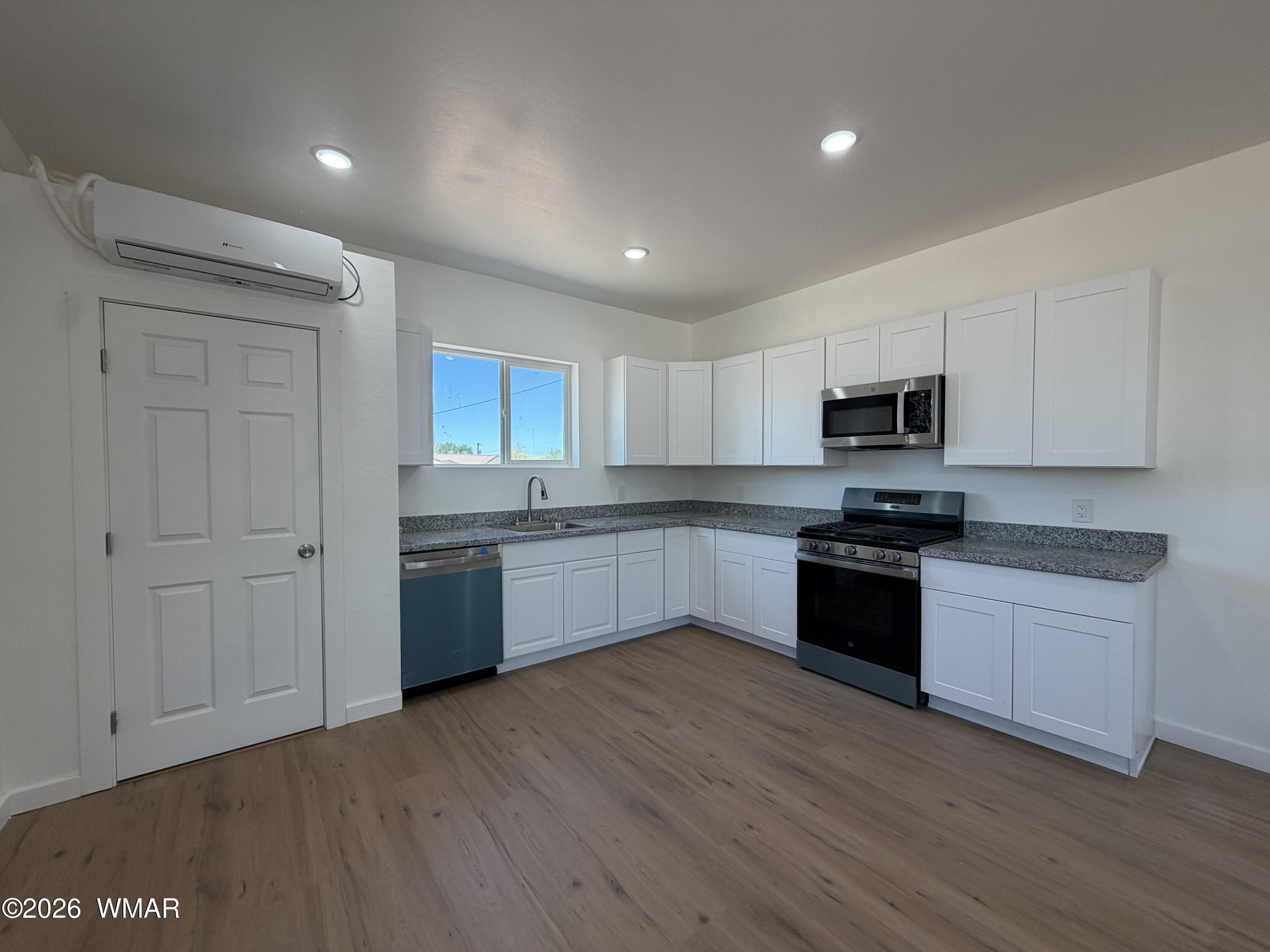 731 Tori Circle Springerville, AZ 85938 - Photo 4 of 19 a kitchen with granite countertop white cabinets and stainless steel appliances