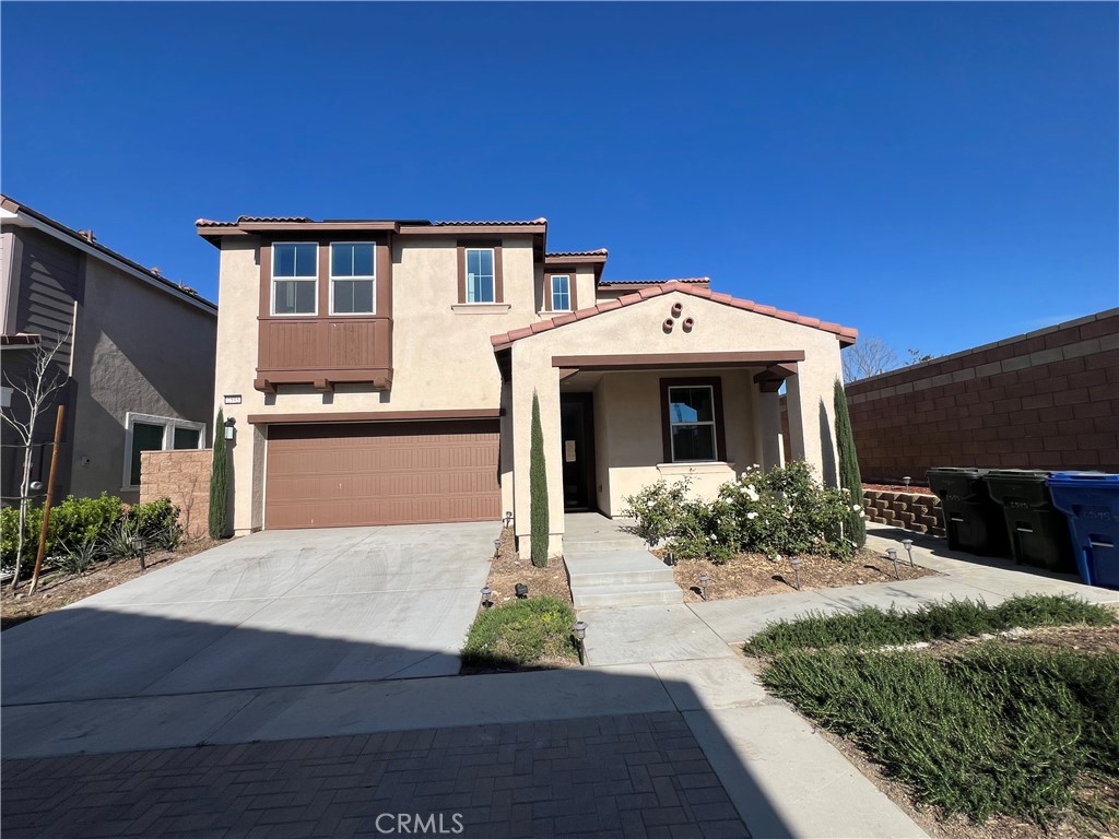 2595 Pheasant Way Ontario, CA 91761 - Photo 1 of 34 a front view of a house with a yard and garage