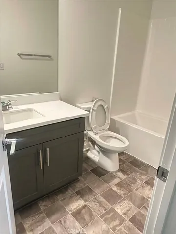 a bathroom with a sink vanity and mirror