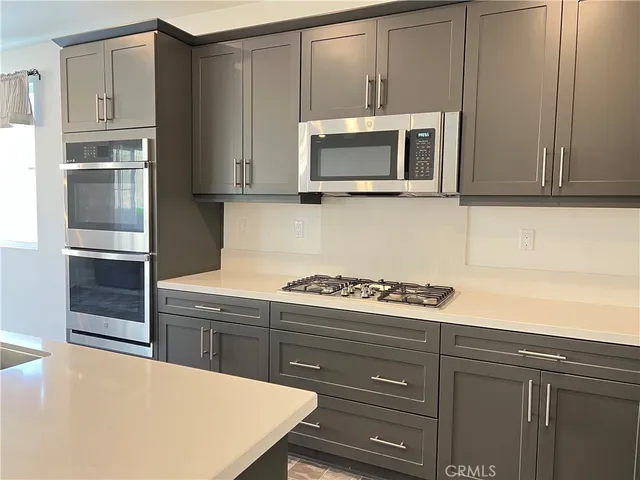 a kitchen with a stove and a microwave