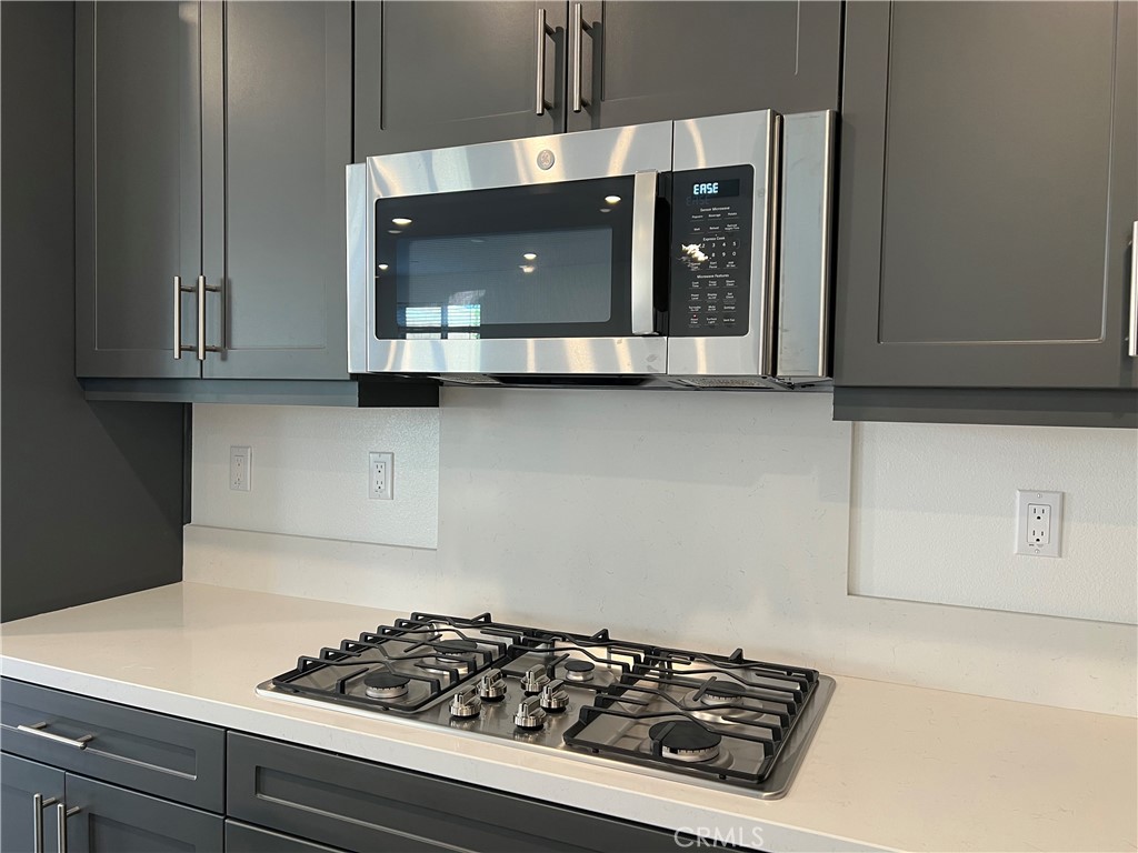 2595 Pheasant Way Ontario, CA 91761 - Photo 9 of 34 a kitchen with a stove and a microwave