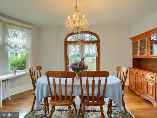 a view of a dining room with furniture wooden floor and chandelier