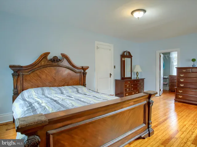 a view of a bedroom with furniture and window