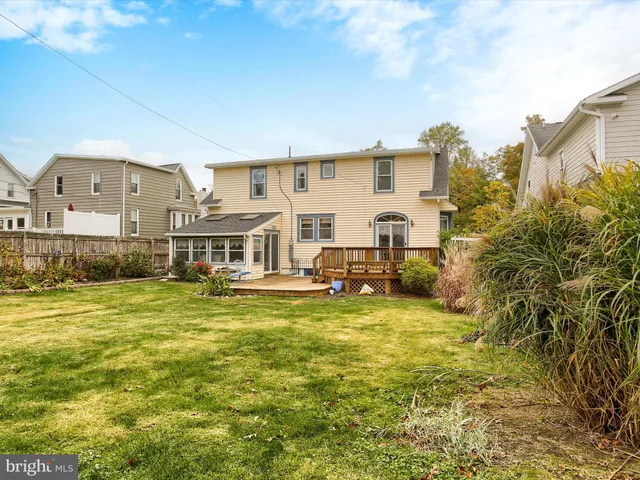 a view of a wooden deck with large trees