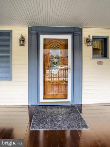a view of a hallway with wooden floor and a hallway