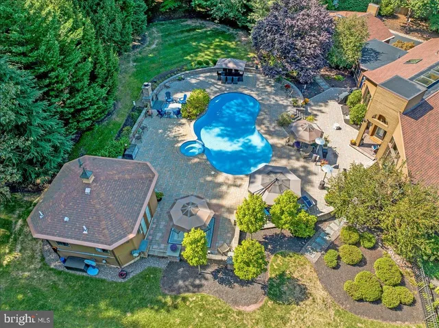 an aerial view of house with yard swimming pool and outdoor seating