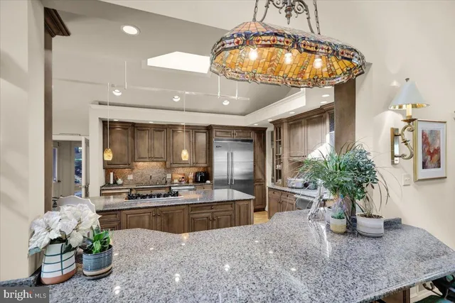 a living room with furniture kitchen view and a wooden floor