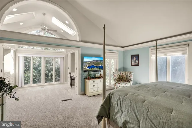 a living room with furniture a flat screen tv and a table