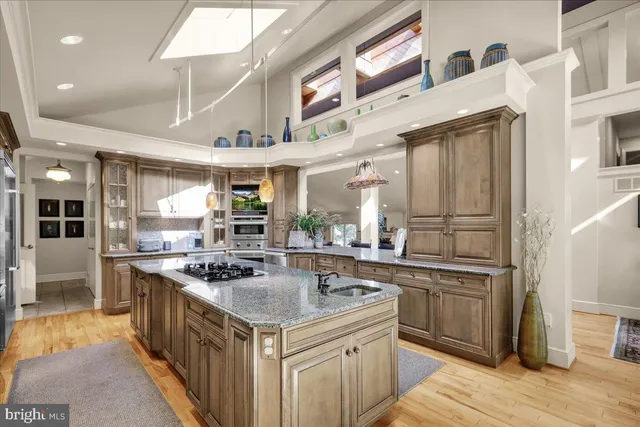 a kitchen with sink and view of living room