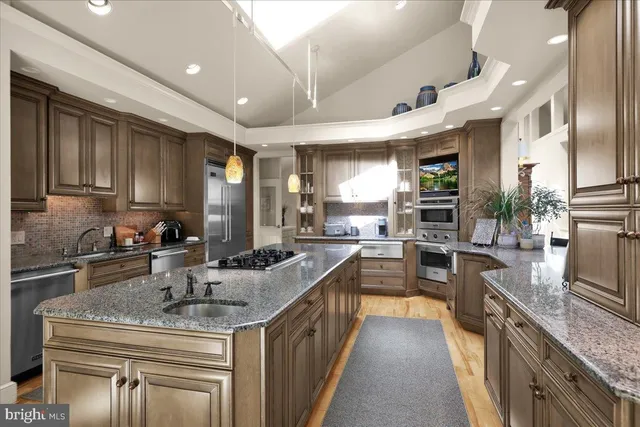 a view of a dining room with furniture a chandelier and wooden floor
