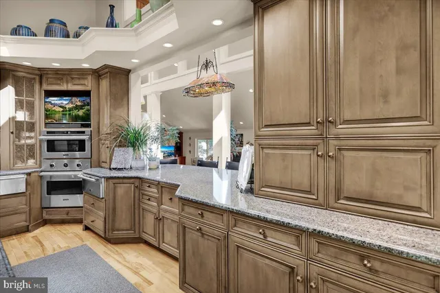 a living room with furniture and a view of kitchen