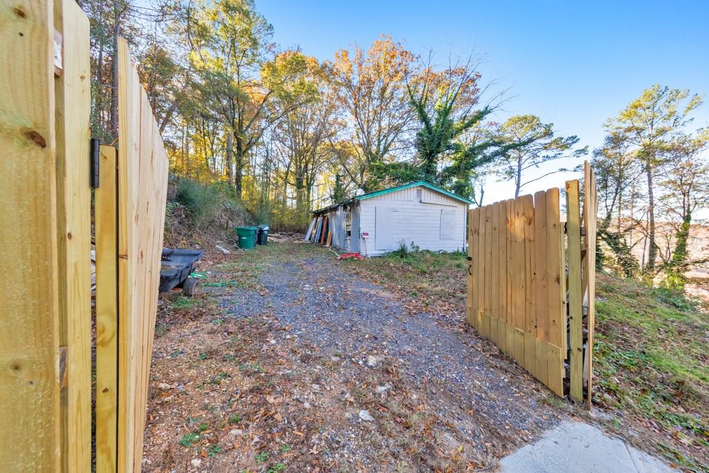 169 Jack Street Silver Creek, GA 30173 - Photo 8 of 10 a view of a backyard with large trees and wooden fence