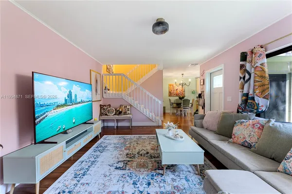 a living room with furniture and a flat screen tv