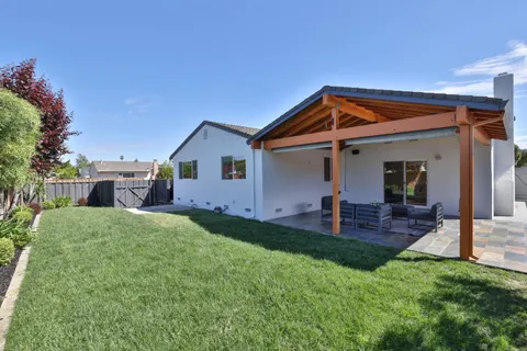 a view of backyard of house and deck