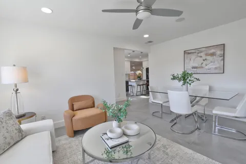 a living room with furniture and a lamp