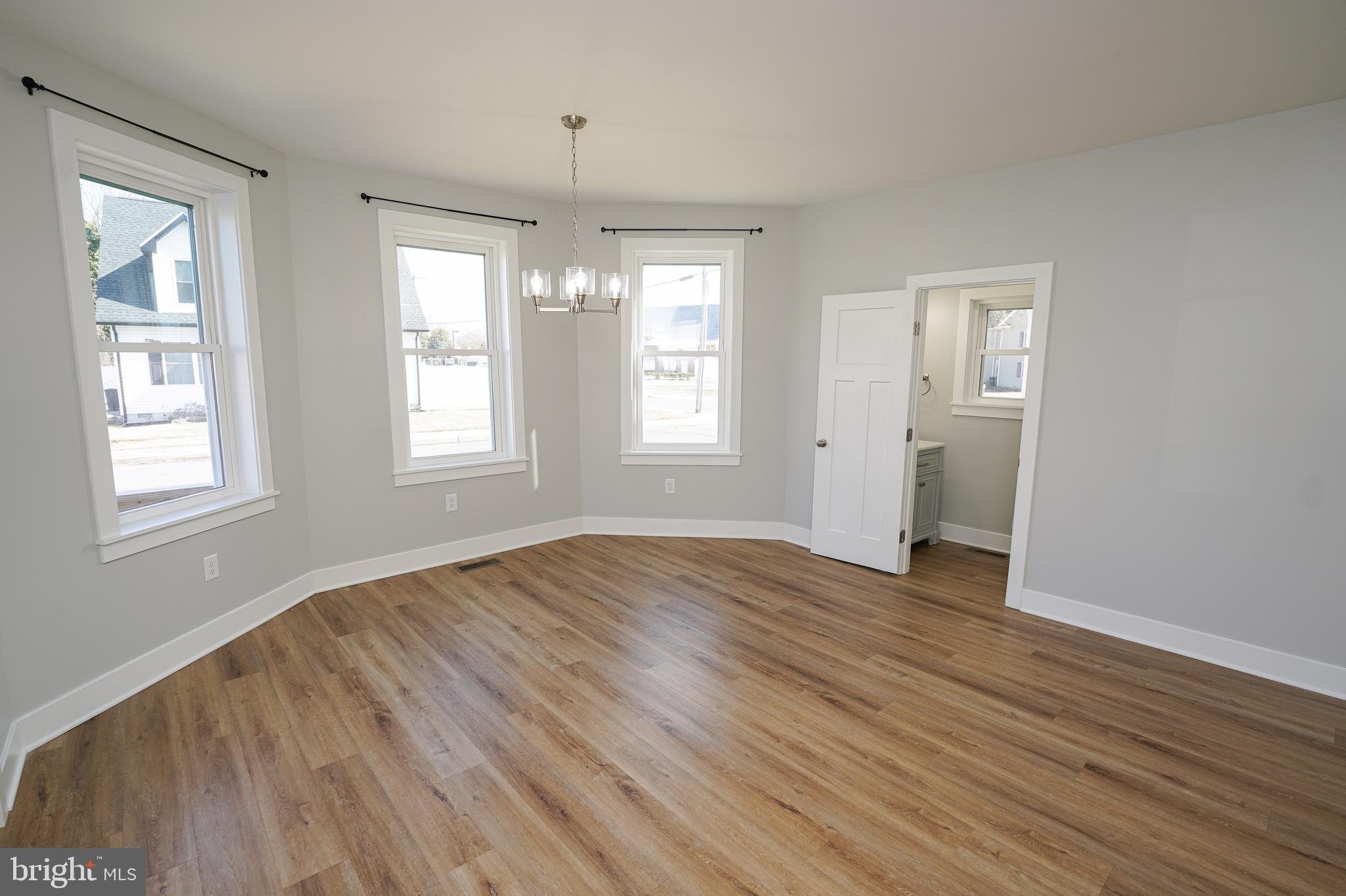 111 East Jewell Street Delmar, DE 19940 - Photo 11 of 59 an empty room with wooden floor and windows