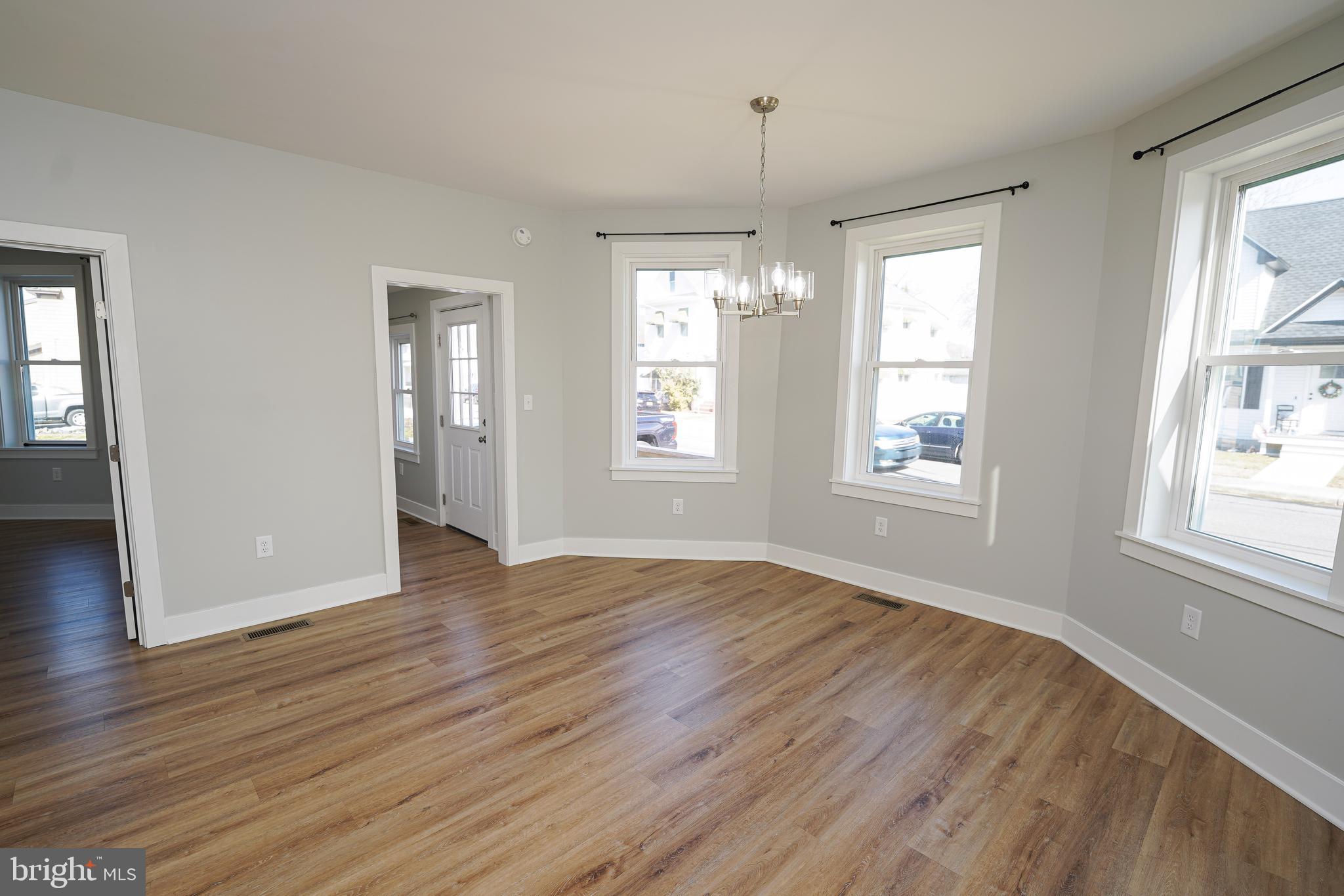 111 East Jewell Street Delmar, DE 19940 - Photo 12 of 59 an empty room with wooden floor and windows