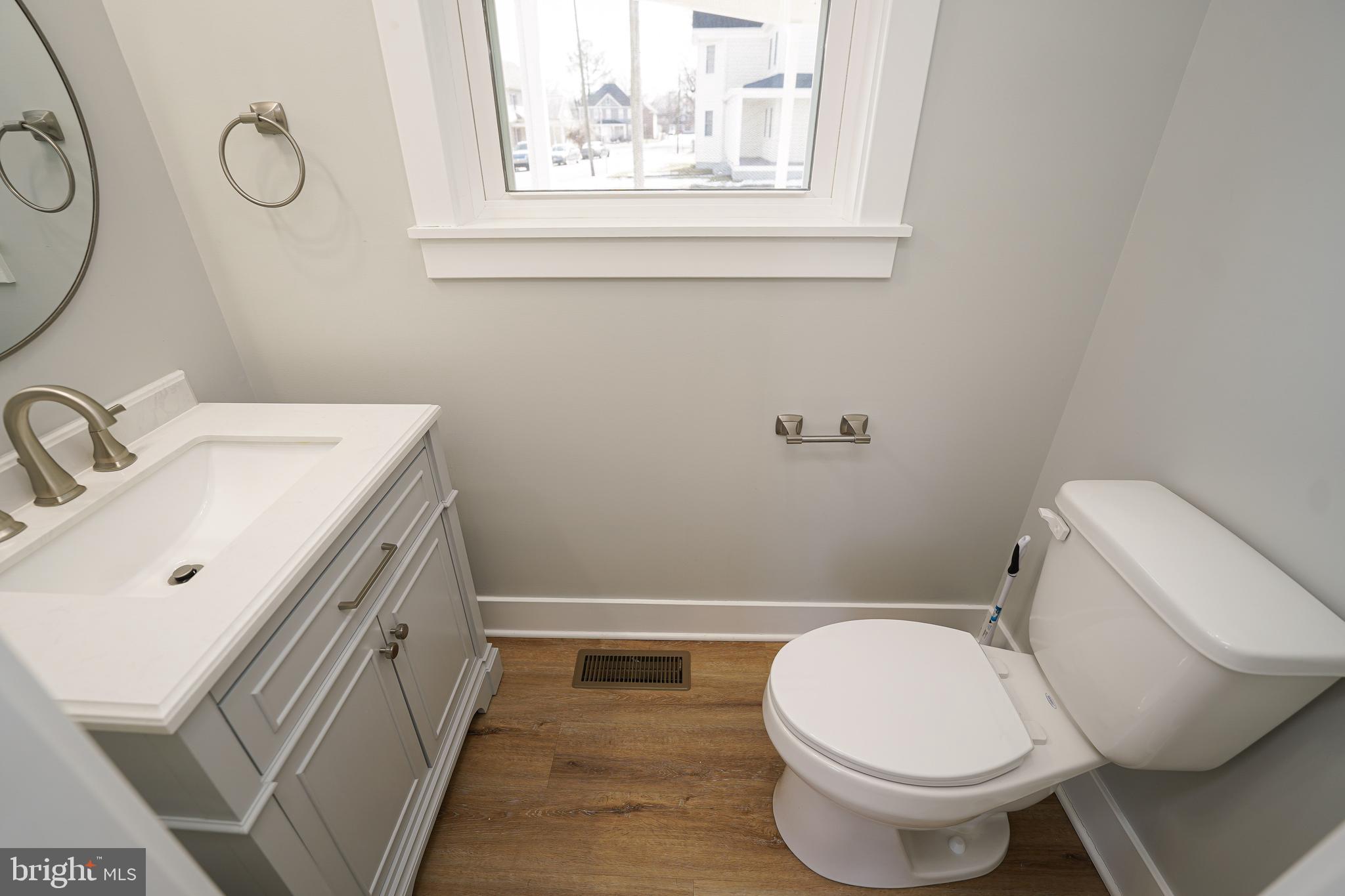 111 East Jewell Street Delmar, DE 19940 - Photo 13 of 59 a bathroom with a sink mirror vanity and toilet