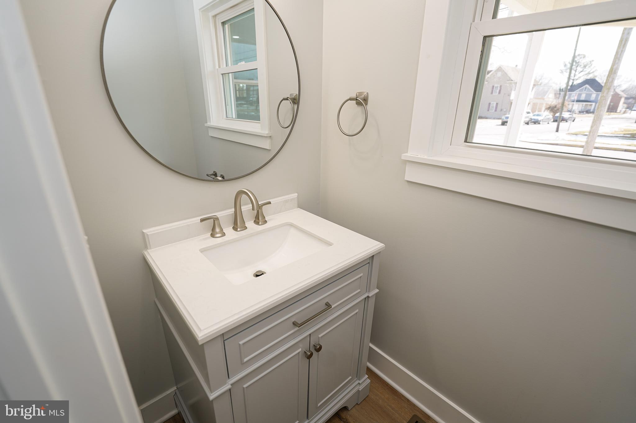 111 East Jewell Street Delmar, DE 19940 - Photo 14 of 59 a bathroom with a sink a vanity and a mirror