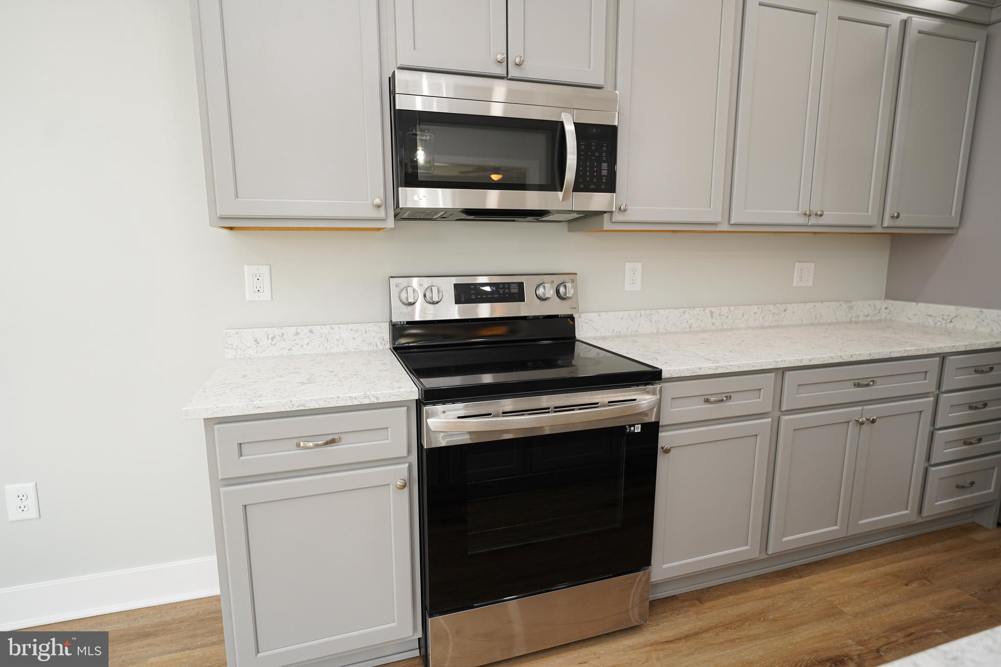 111 East Jewell Street Delmar, DE 19940 - Photo 18 of 59 a kitchen with stainless steel appliances granite countertop a stove a microwave and cabinets