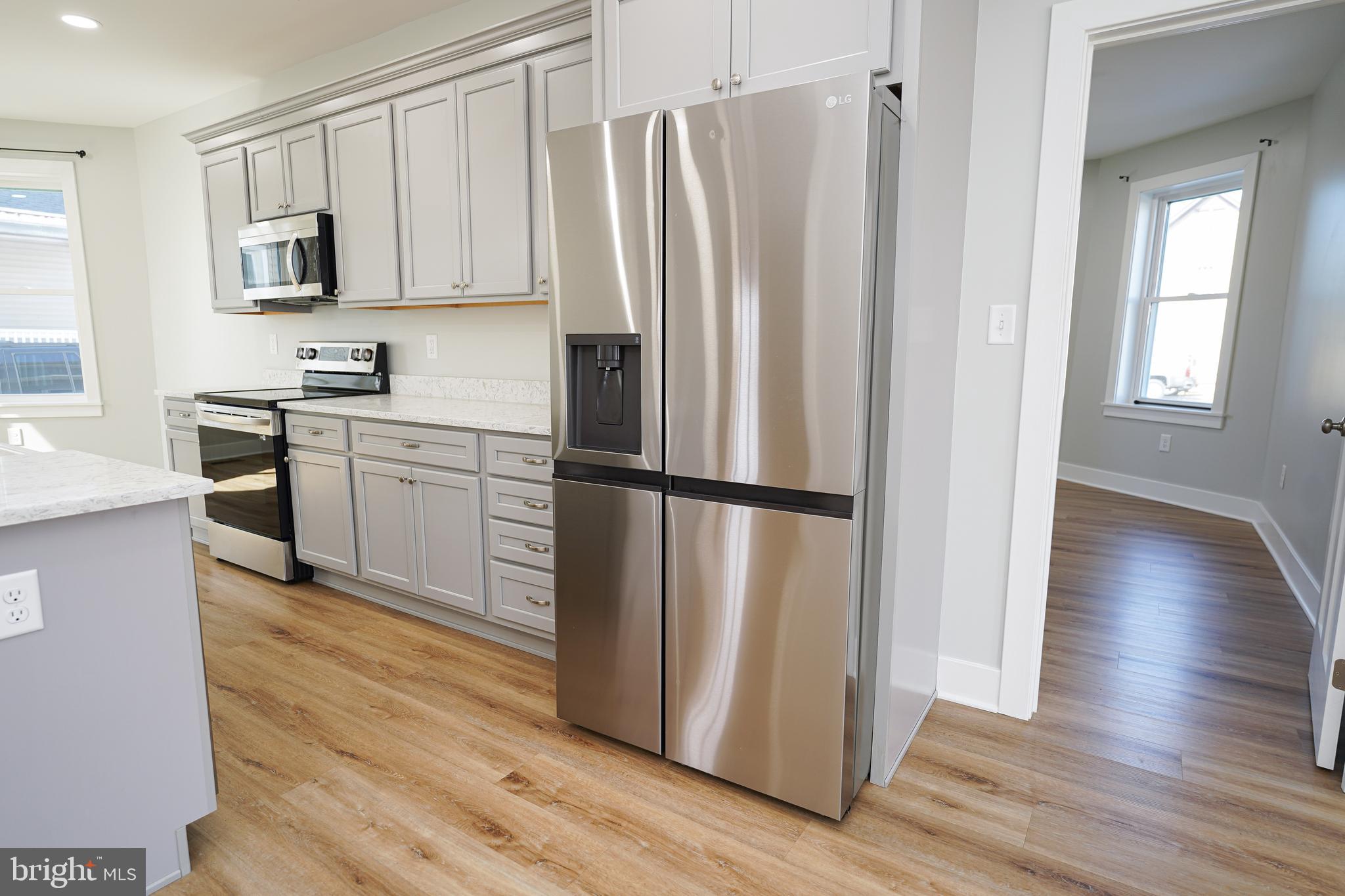 111 East Jewell Street Delmar, DE 19940 - Photo 19 of 59 a kitchen with stainless steel appliances granite countertop a refrigerator sink and microwave