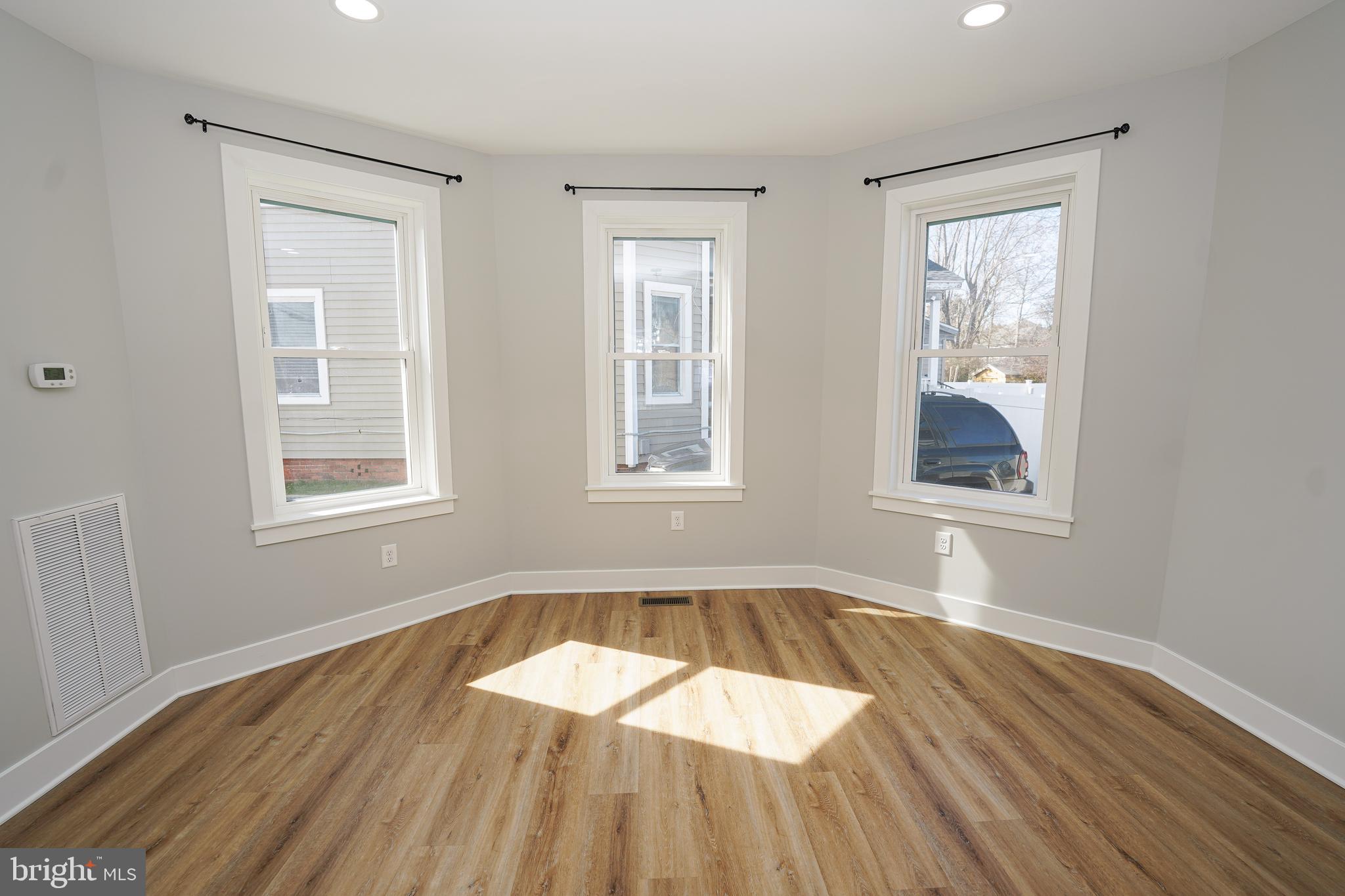 111 East Jewell Street Delmar, DE 19940 - Photo 20 of 59 a view of an empty room with wooden floor and a window