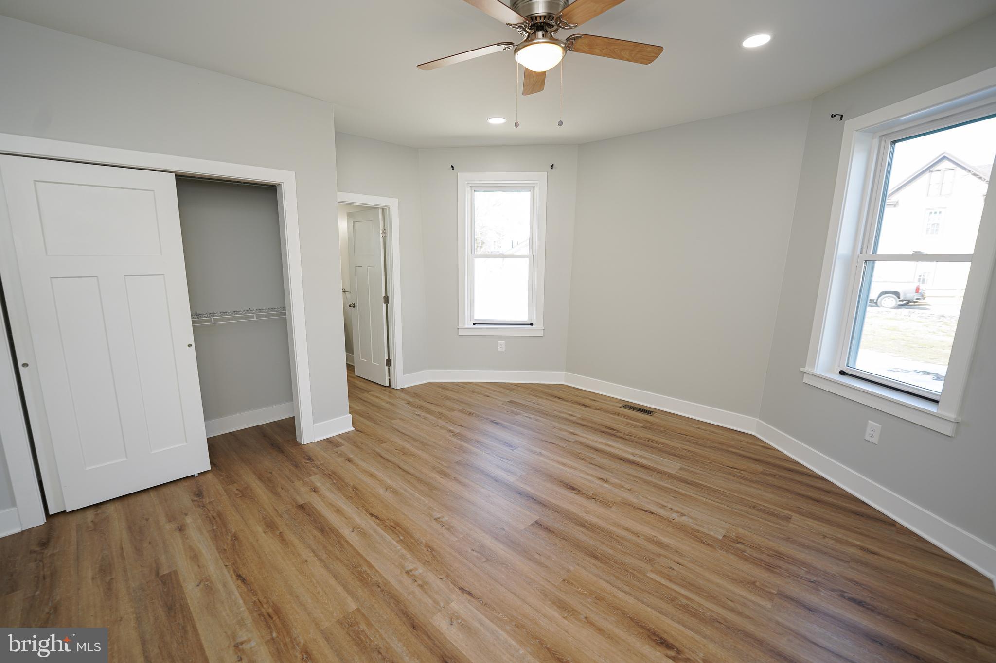 111 East Jewell Street Delmar, DE 19940 - Photo 22 of 59 an empty room with wooden floor and windows